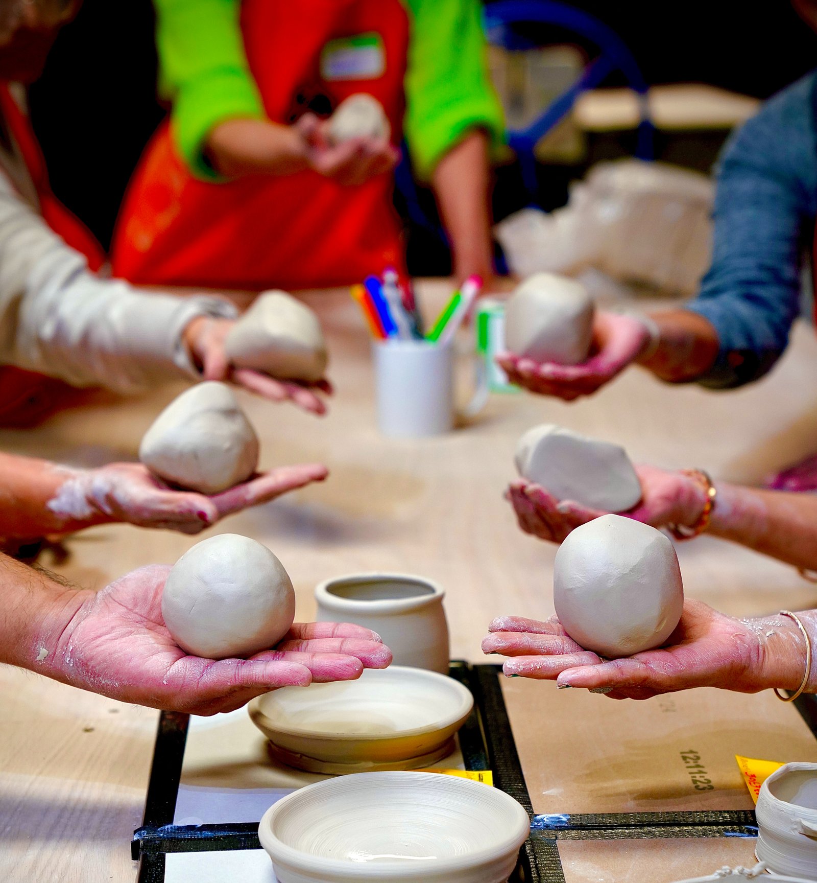 Eye-level view of a pottery studio with glistening ceramic pieces