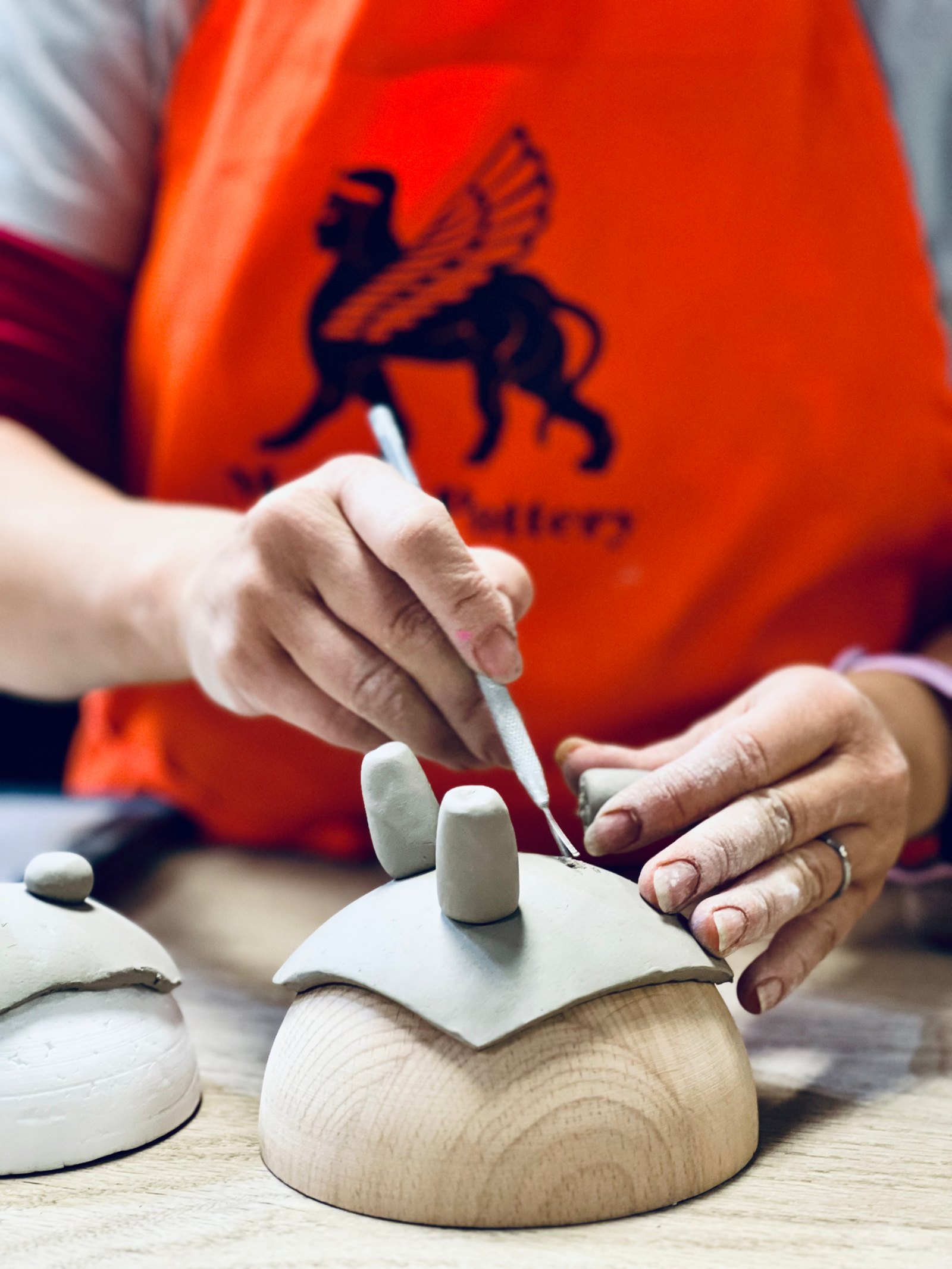 Eye-level view of pottery wheel with clay being shaped